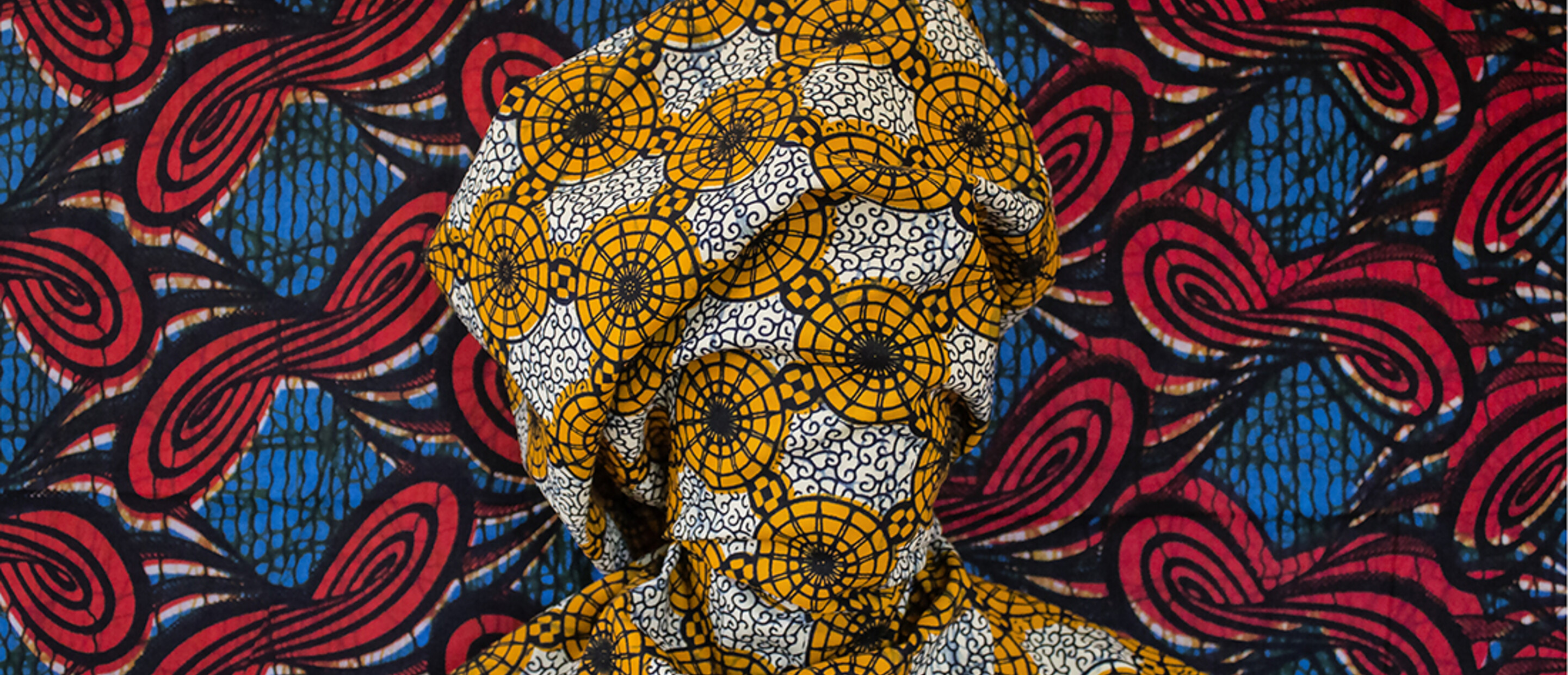 Bust wrapped in yellow white patterned fabric 