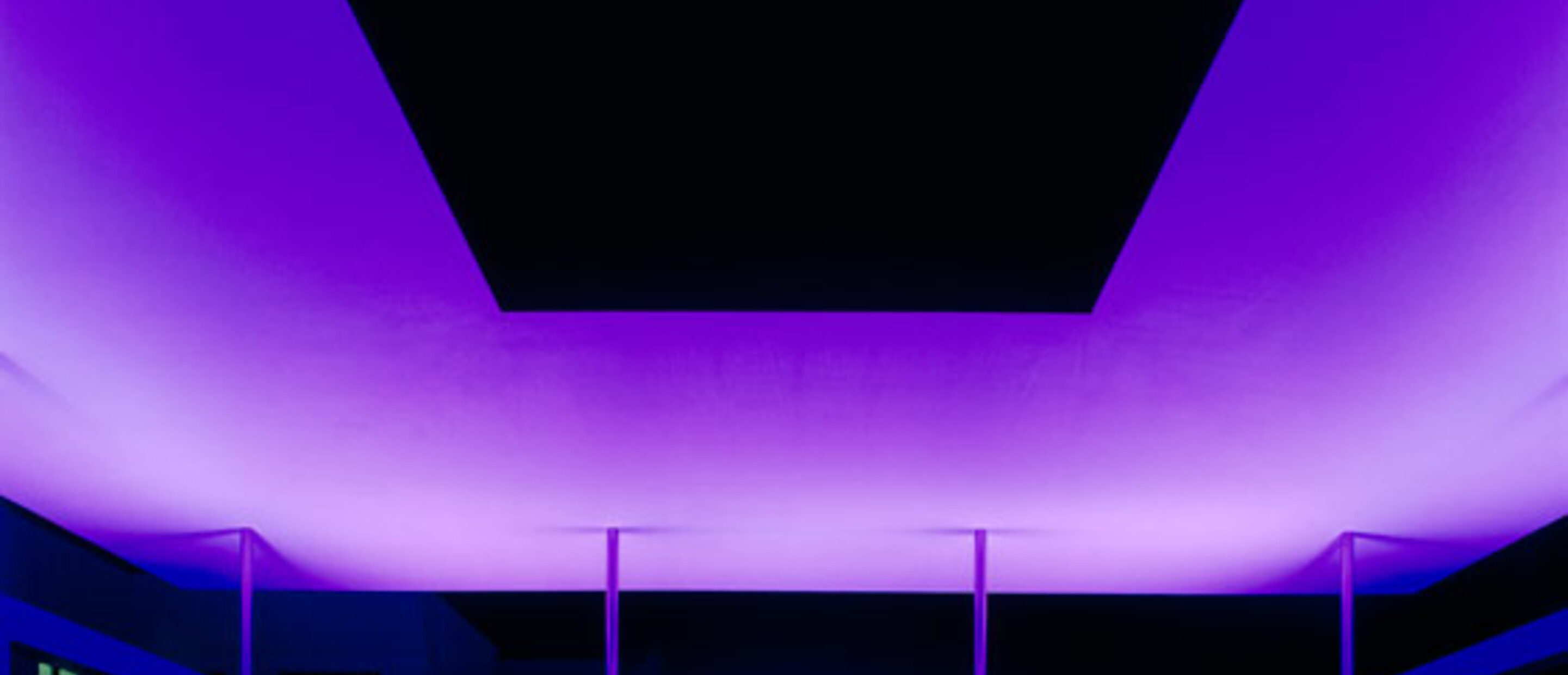 Nighttime view of the James Turrell Skyspace with purple lighting