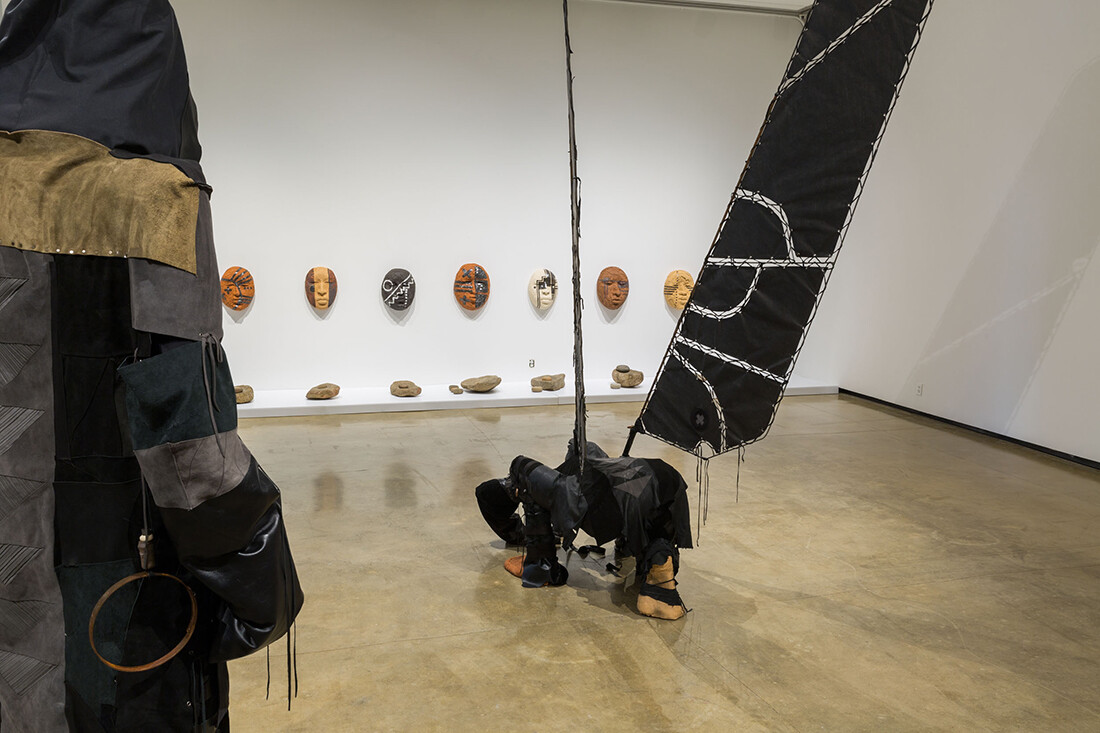 Installation view of sculpture on wall and on floor