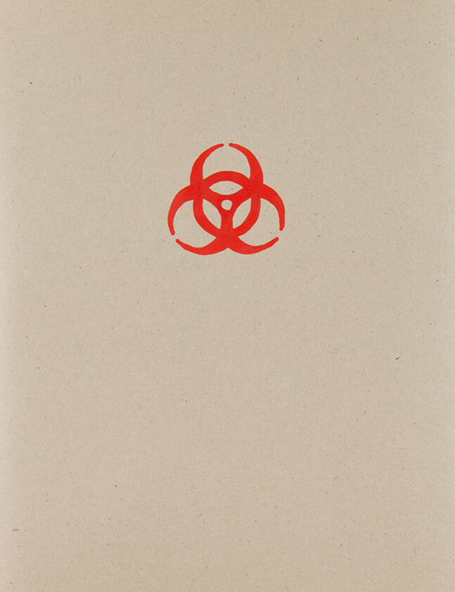 Red hazard sign on cardboard
