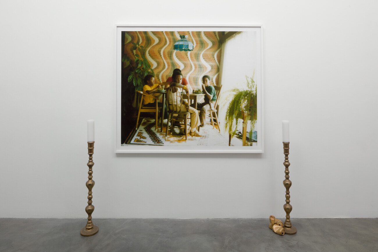Framed photograph with two candles on either side of it