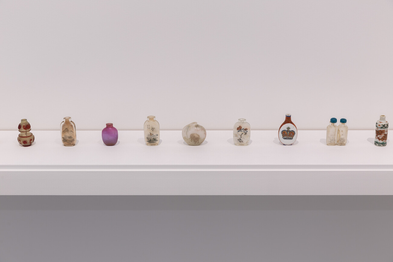 Row of Chinese snuff bottles in gallery space