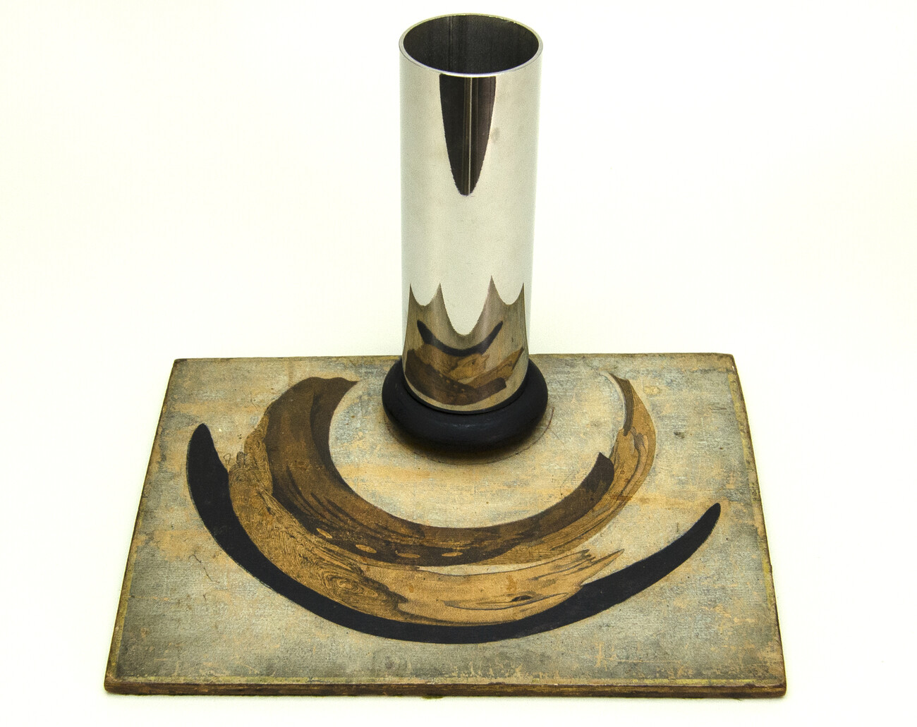 reflective silver cylinder on top of panel with distorted image