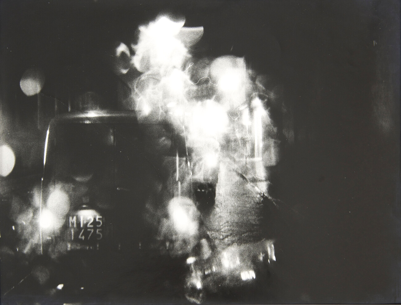 black and white photograph of car and smoke