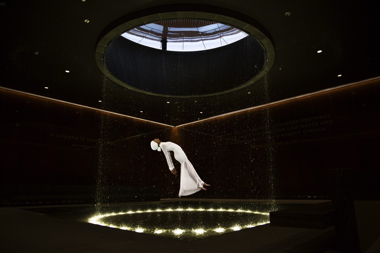 woman in white floating in black room