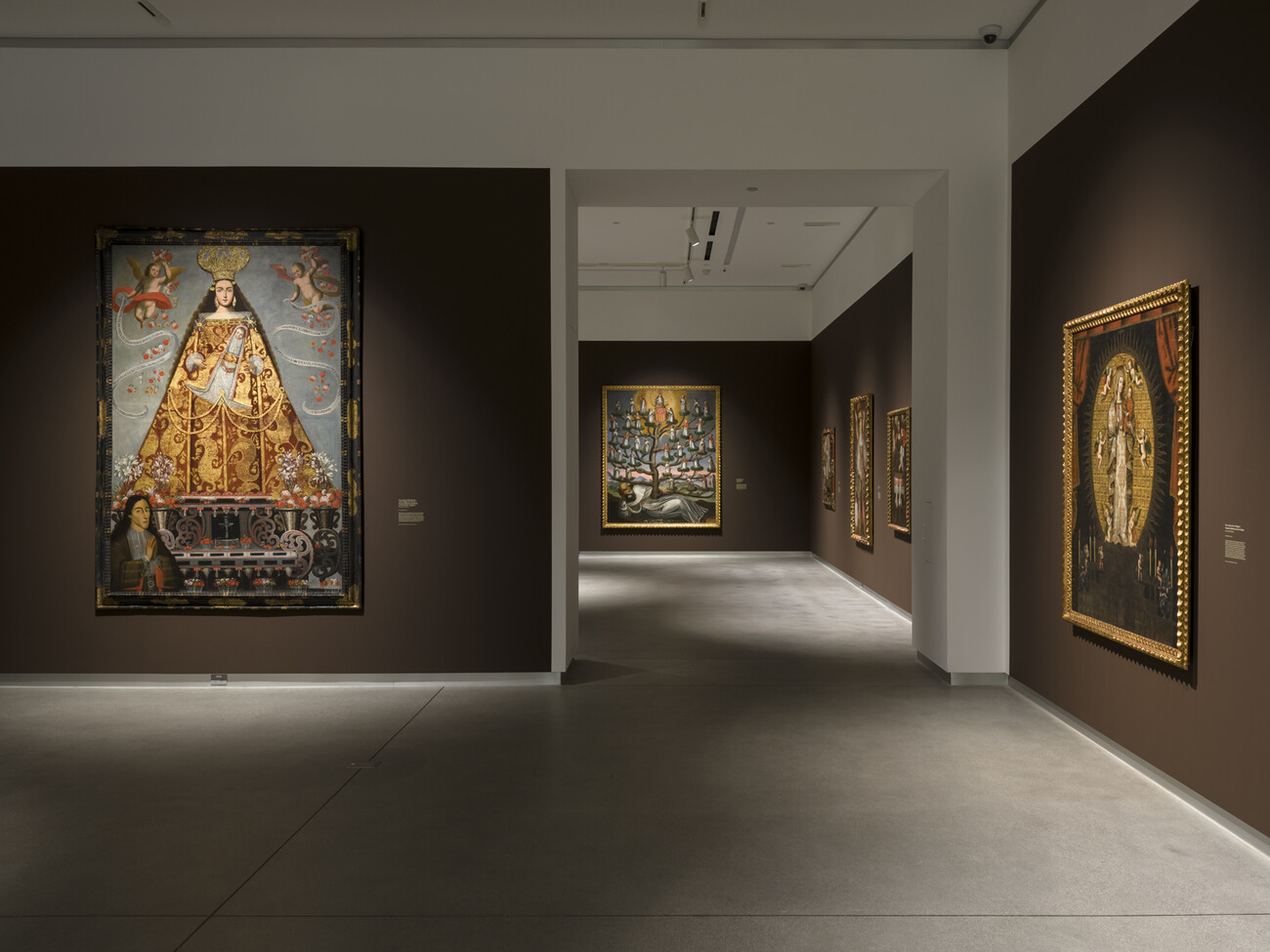brown gallery with doorway and large paintings