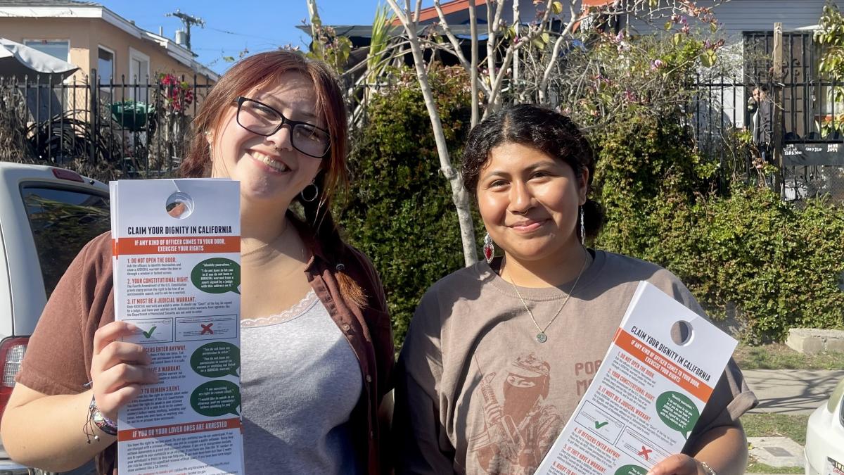 Students in a photo holding a flyer