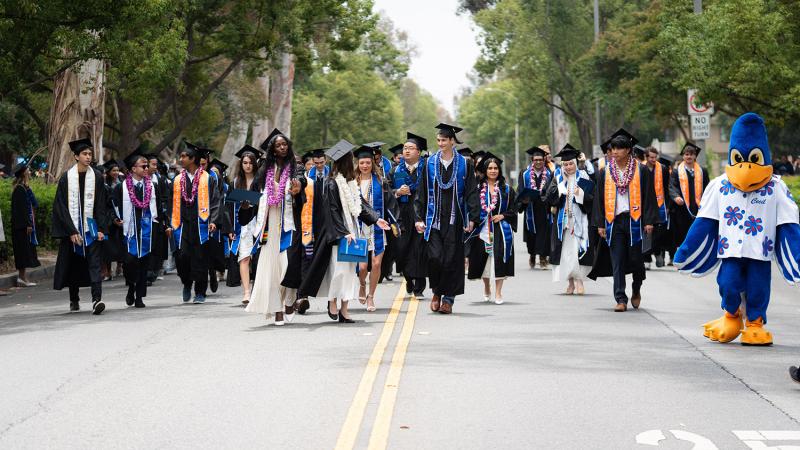 students walking down college avenue for commencement