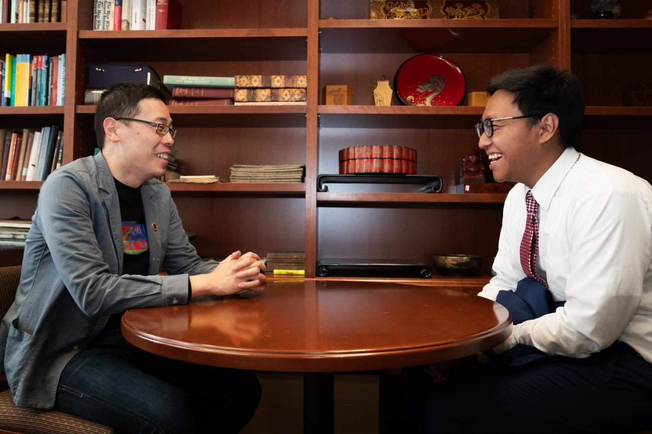 Feng Xiao, left, and Htet Wai Yai laugh in Xiao's office