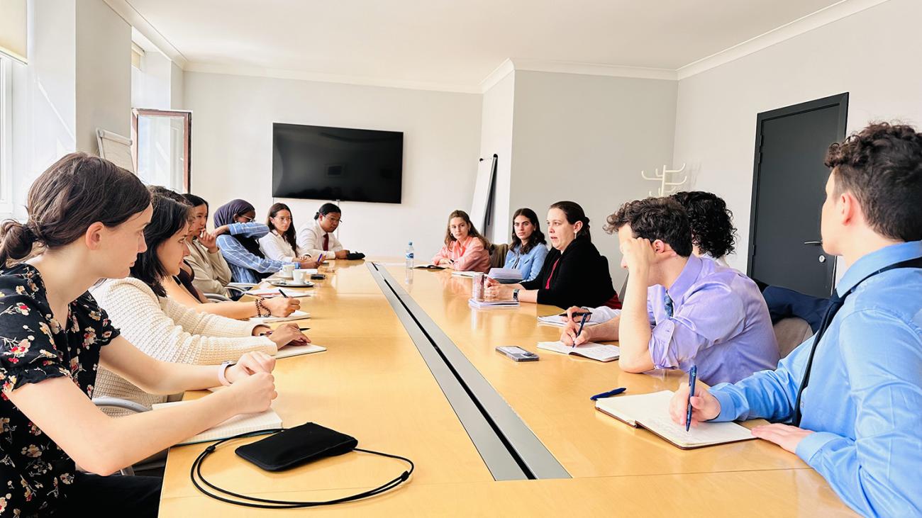 students gathered around a meeting table