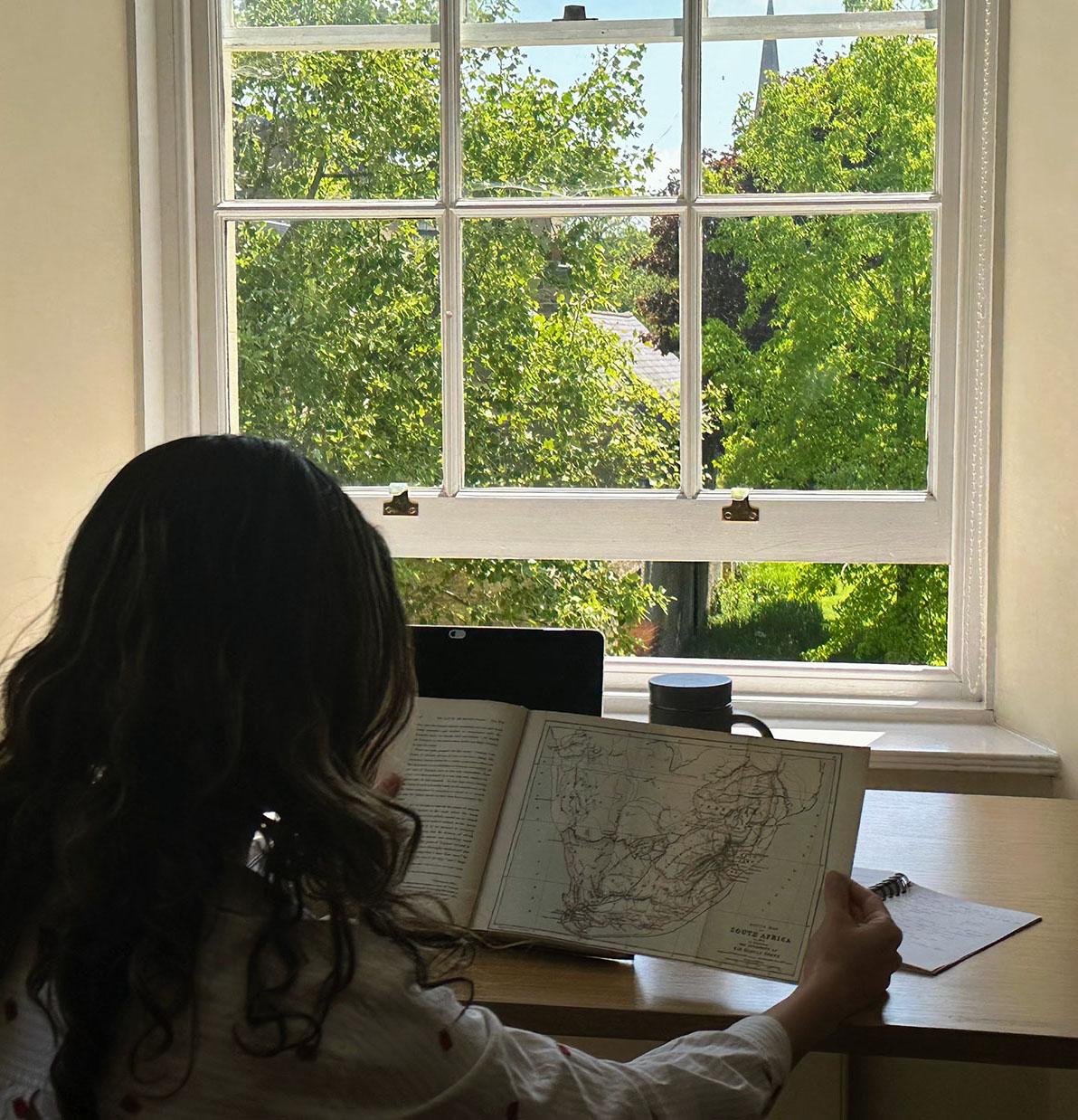 Rya Jetha studies in the Downing College library at the University of Cambridge