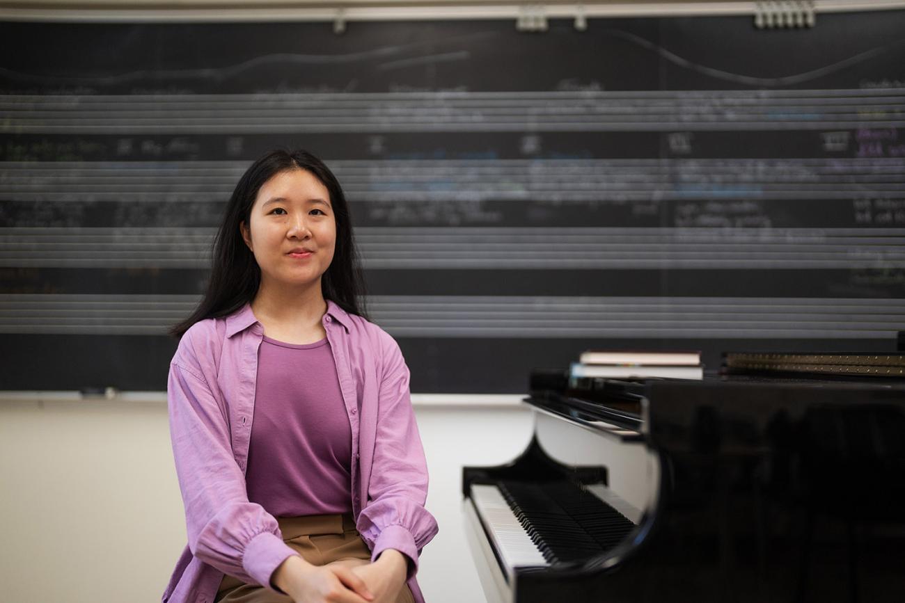 Melinda Yang seated at piano