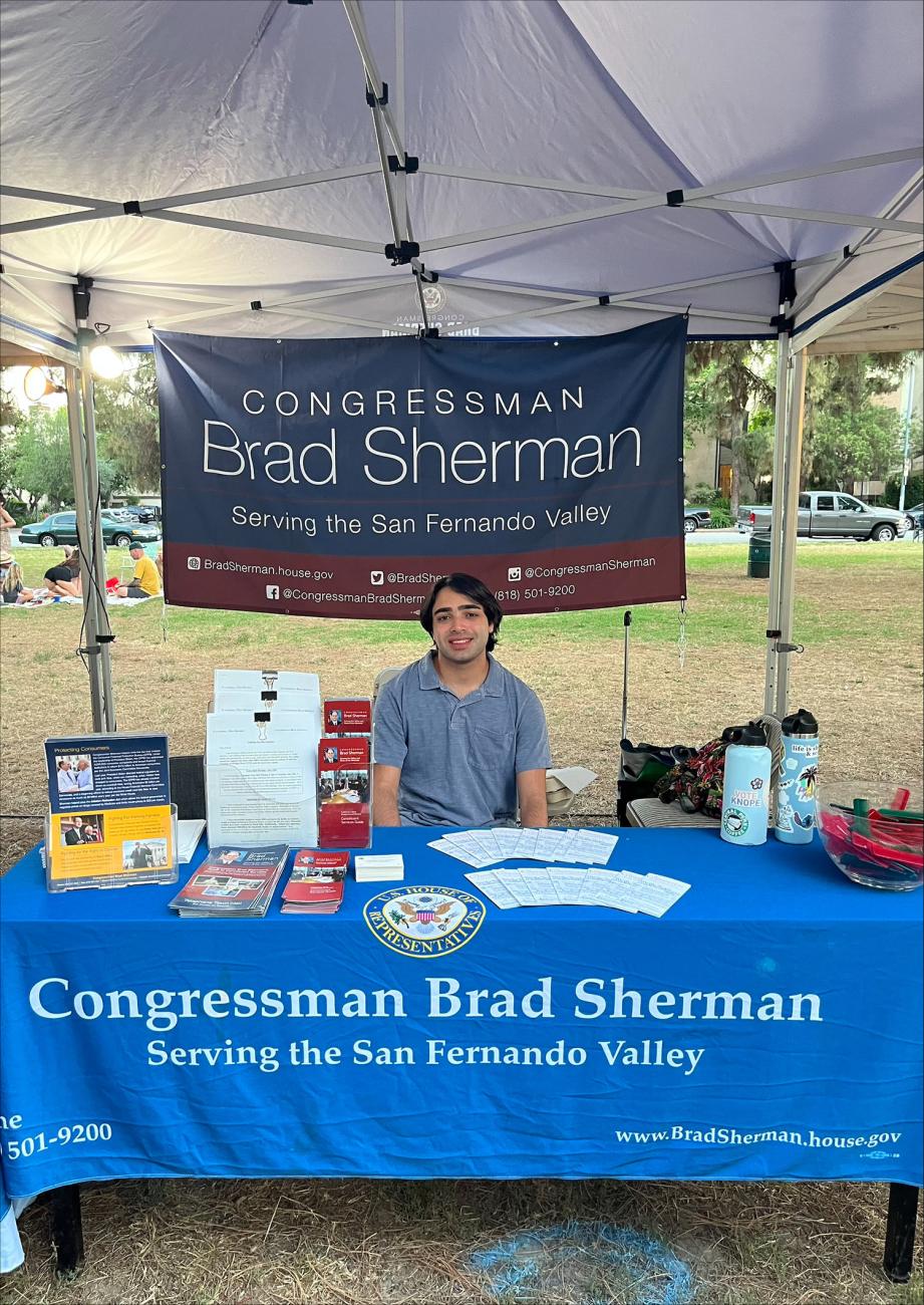 Student sits at table in campaign booth