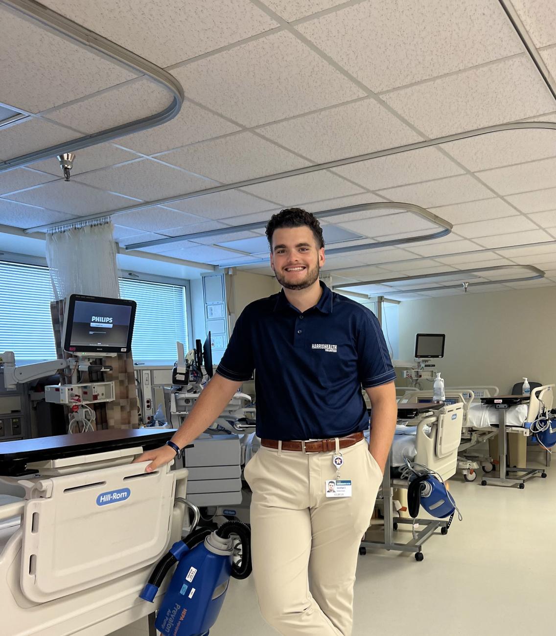 Student standing next to hospital bed in hospital