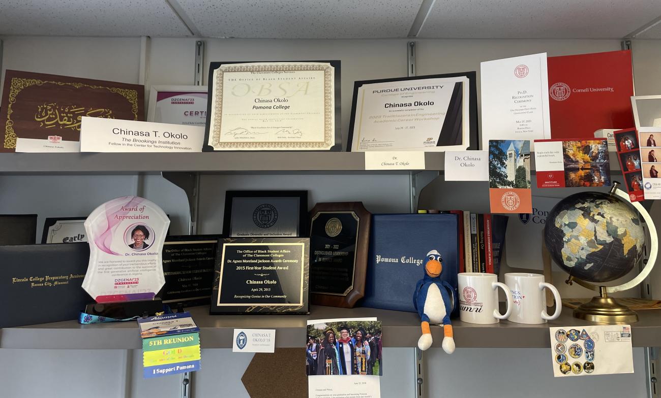 A collection of awards and plaques on shelves