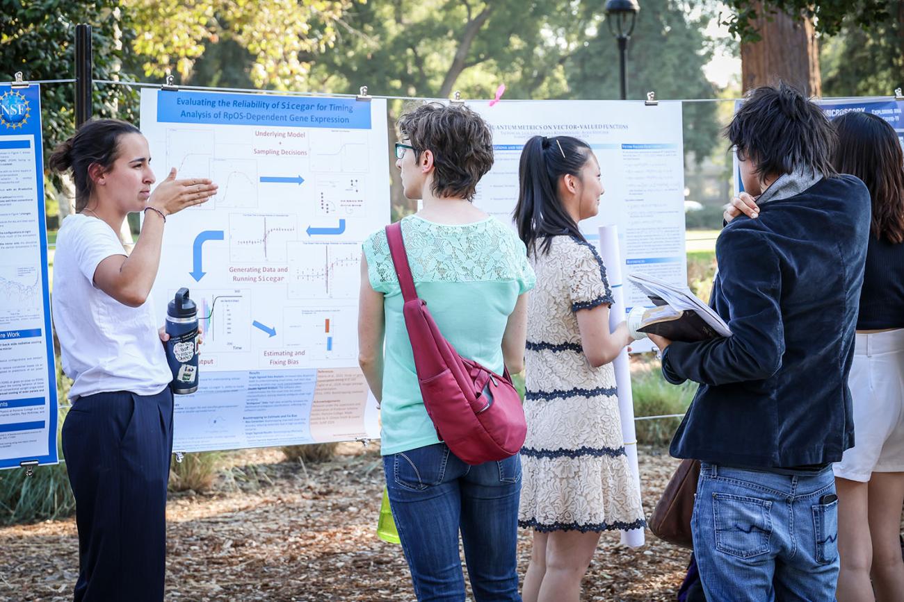 Federica Domecq Lacroze ’26 presents her poster to students who stopped by