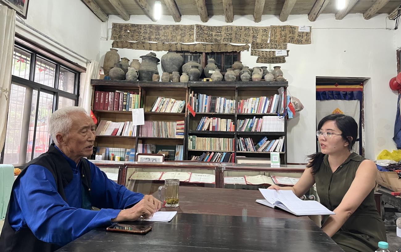 A man sits across a table from Yanshuo Zhang