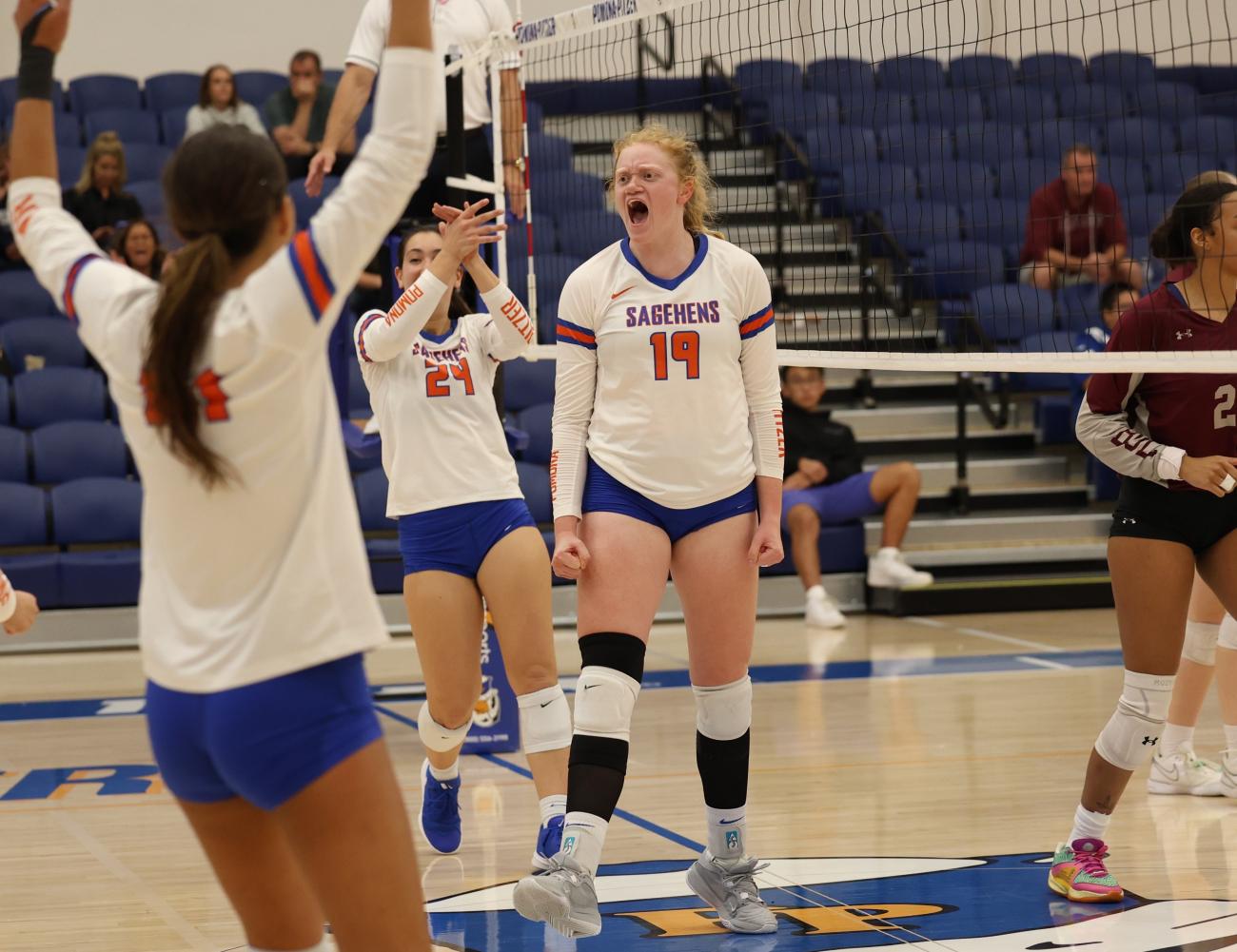 Kellan Hayes celebrates after winning a point in volleyball