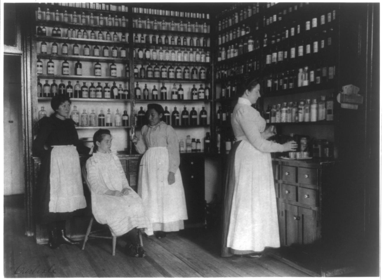 Women stand in an infirmary