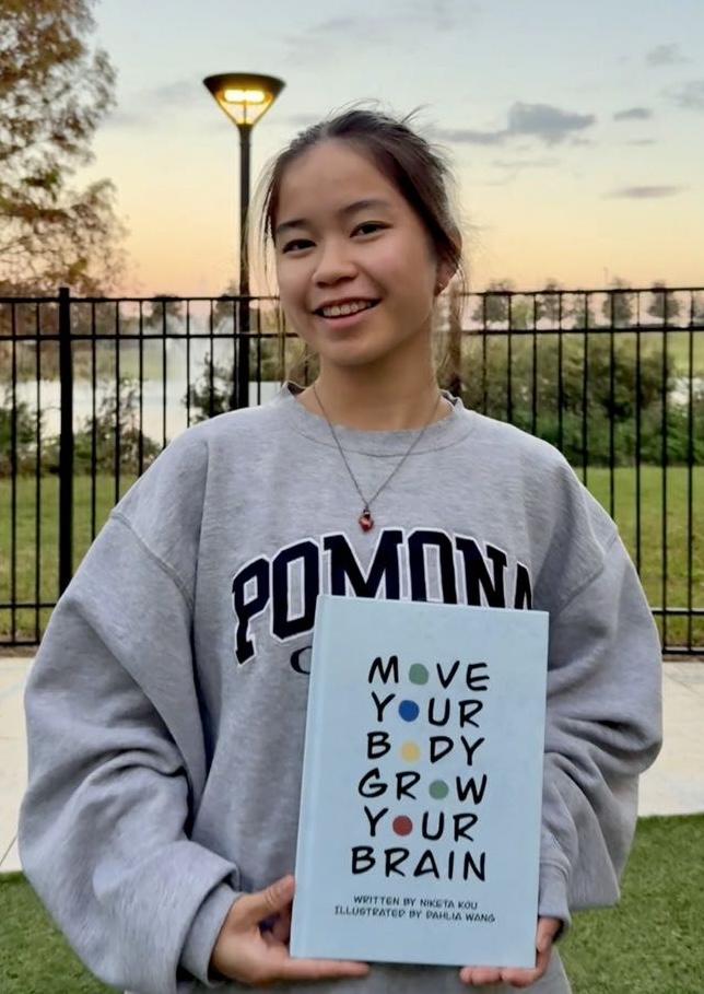A young woman holds her book