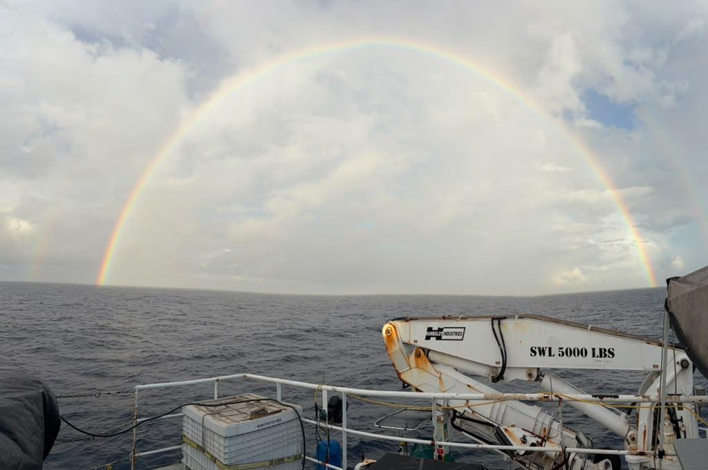 View over ocean, with rainbow in the sky