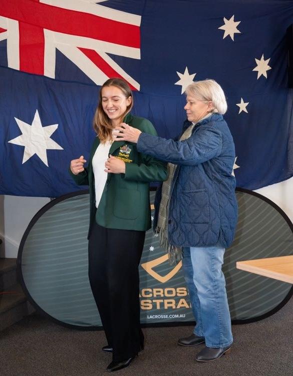 A woman puts a jacket on another woman