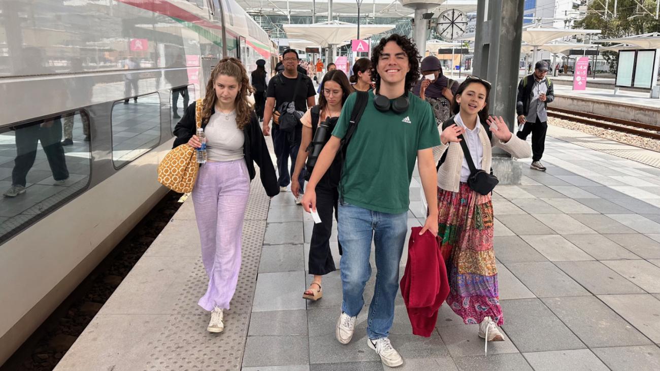 students walking on a train platform