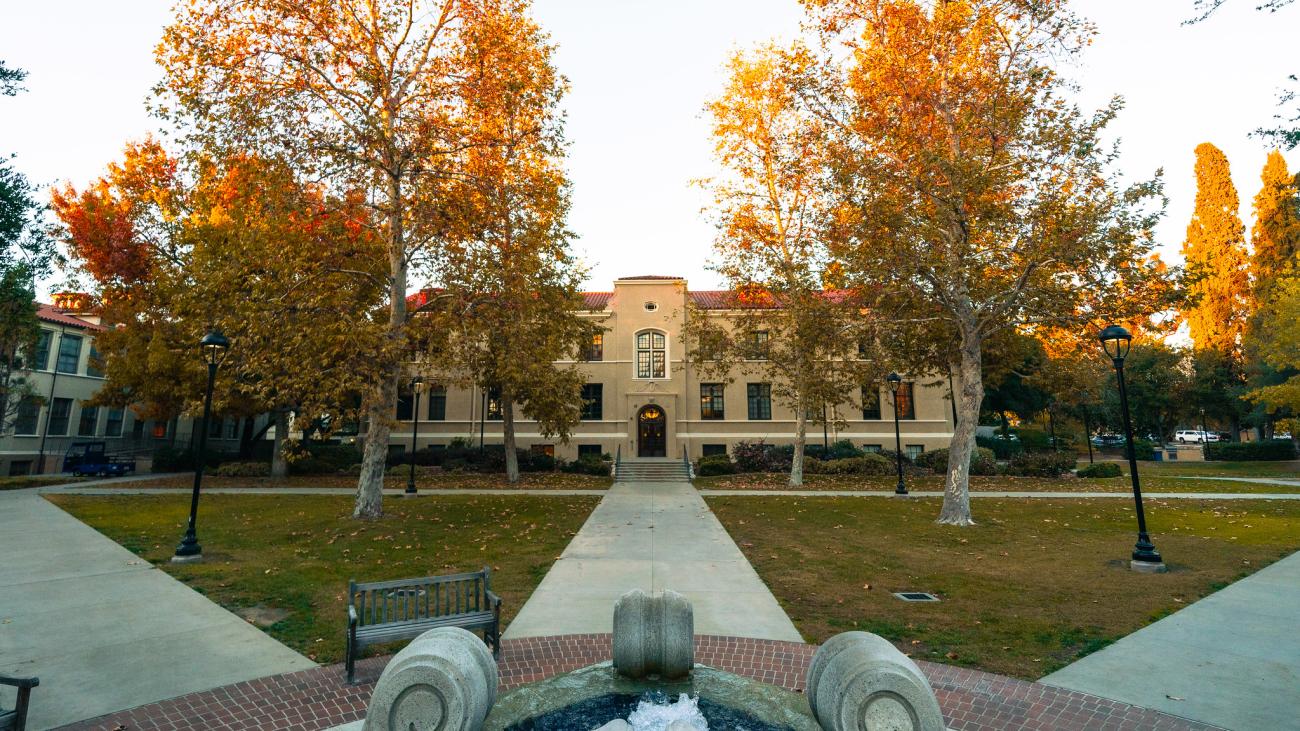 water fountain with three different walking paths leading to buildings. 