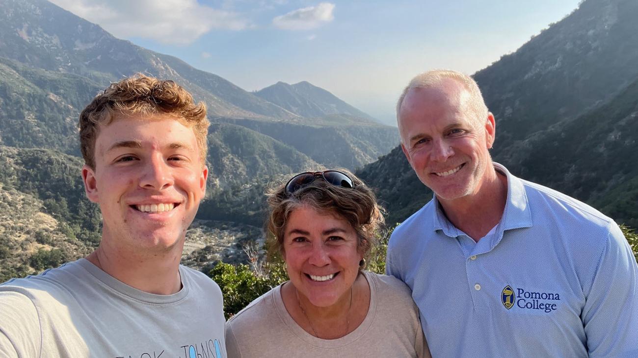 Bill, Alexa and Liam Riley smile together on a hike