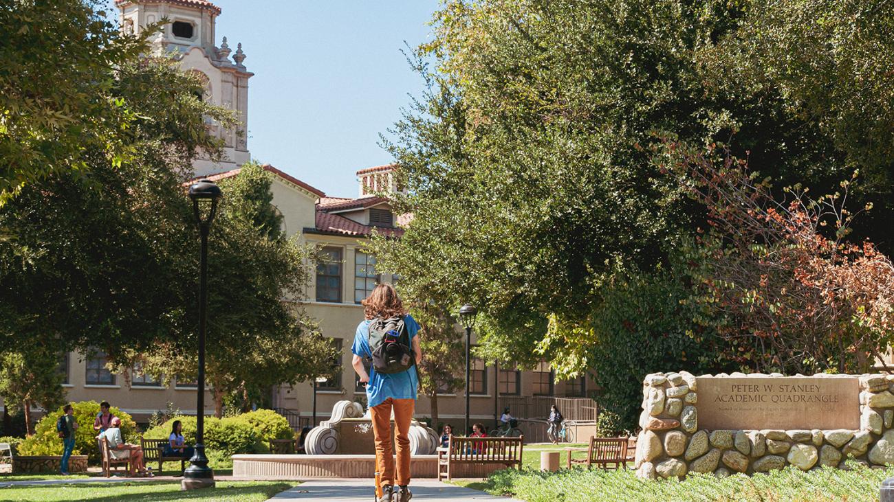 Student on walkway on Pomona campus