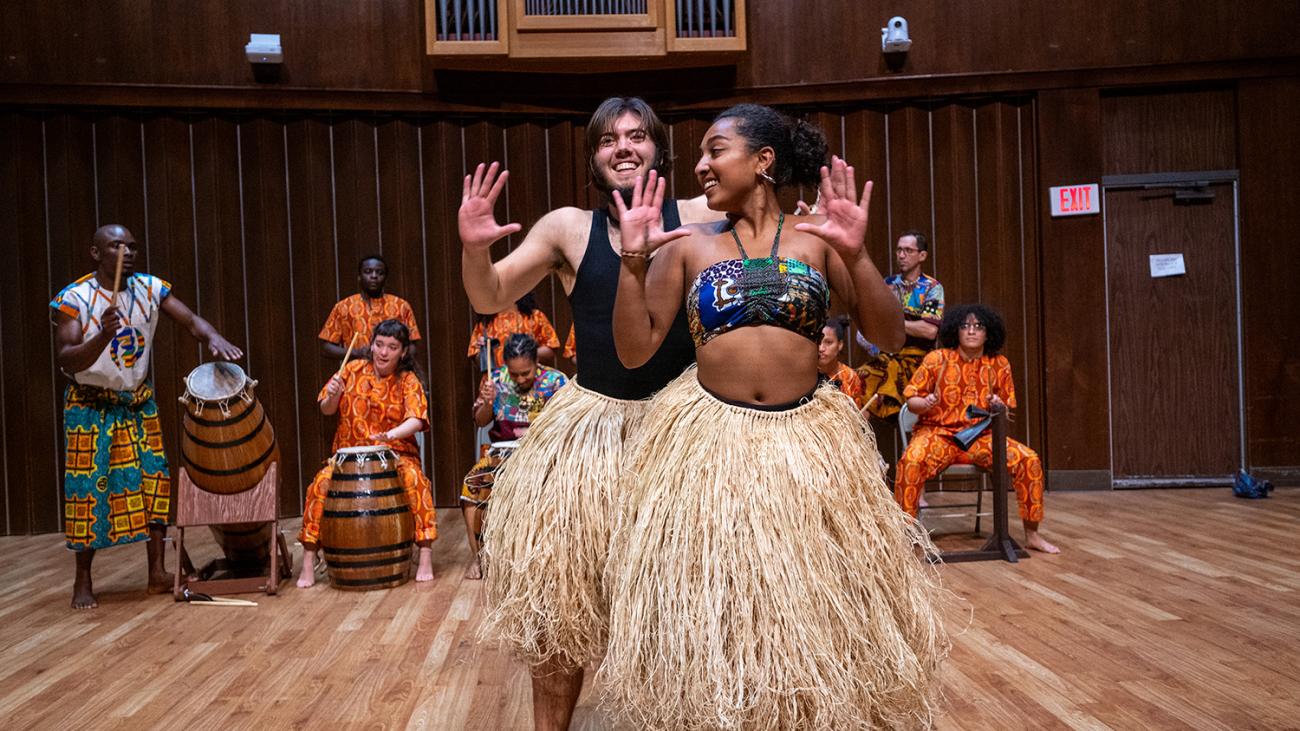 Dancers and drummers perform in the West African Music Ensemble