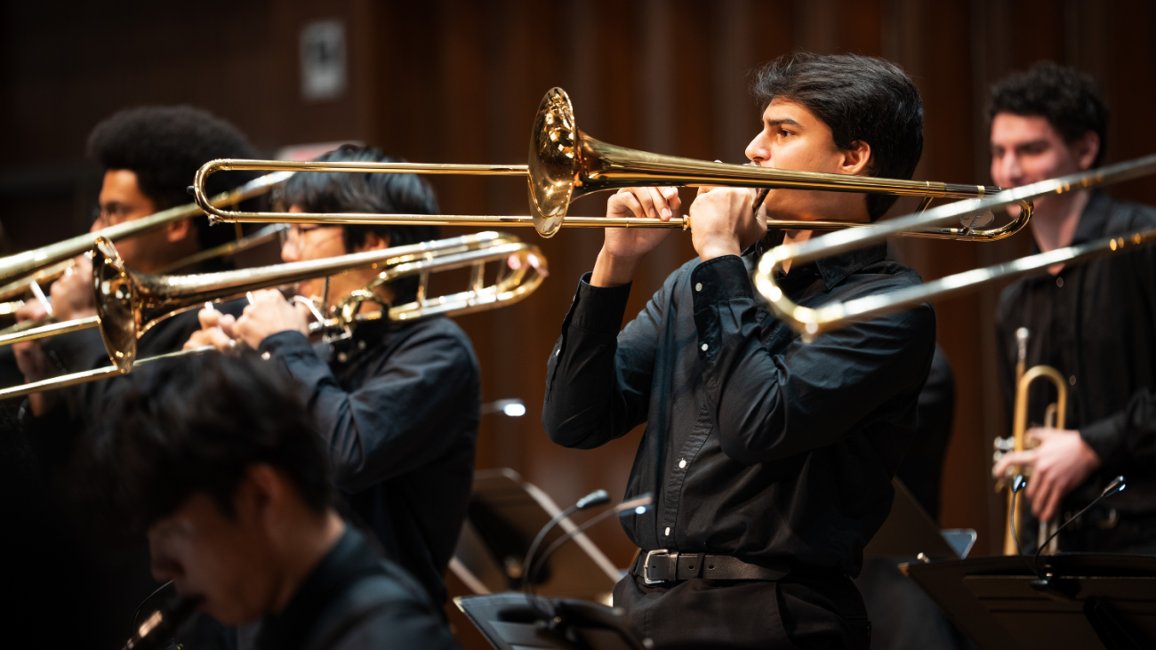 A line of trombonists plays in the Jazz Ensemble.