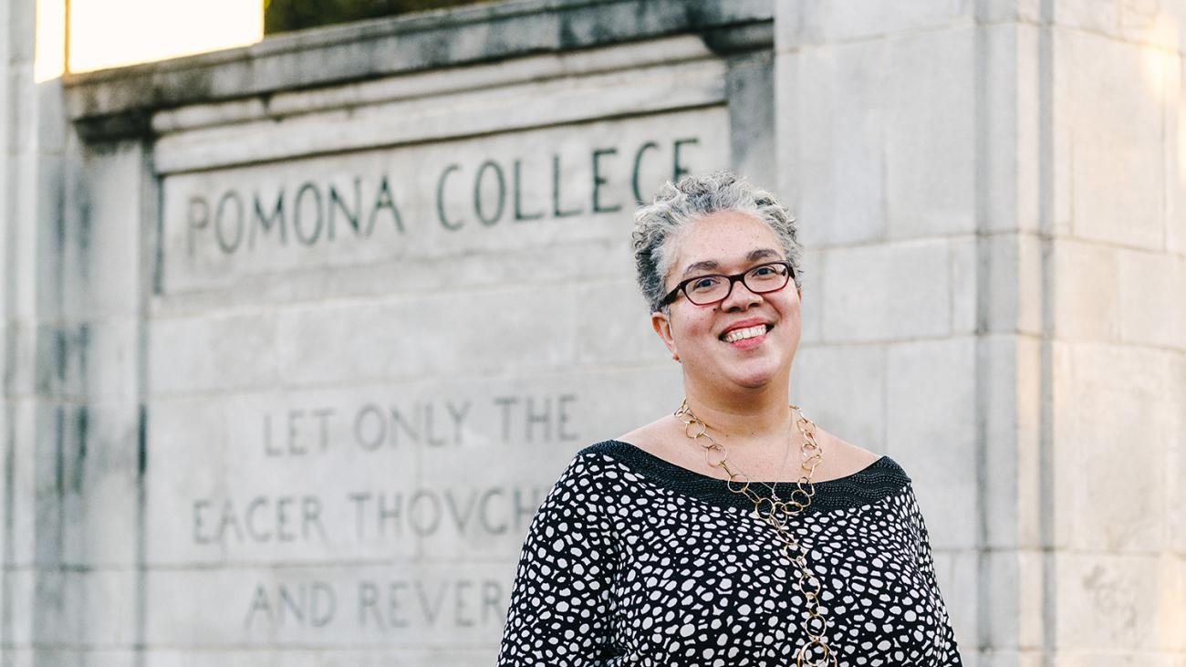 President G. Gabrielle Starr horizontal in front of the campus gates